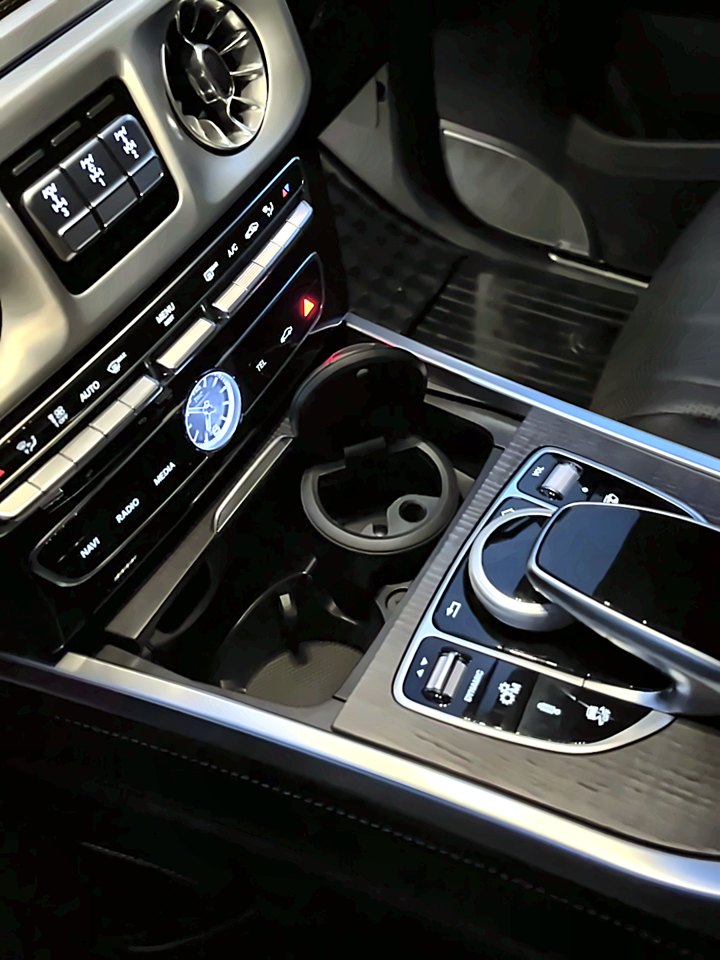 The same G63 center console and cupholders clean after the detail.