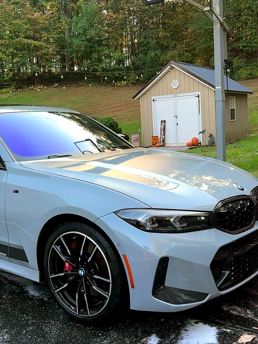 Grey BMW M340i with red brake calipers after an exterior detail.