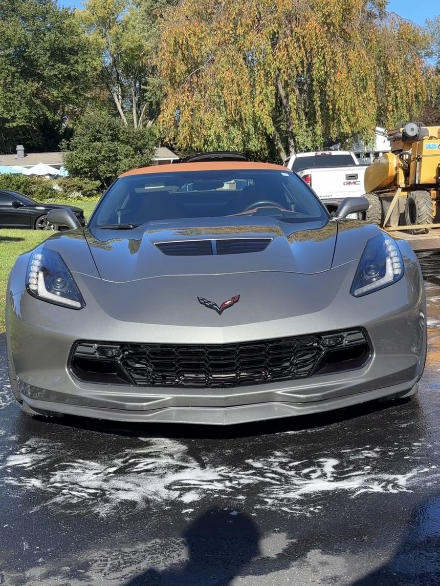 Silver Chevrolet Corvette C7 after an exterior detail in a driveway.