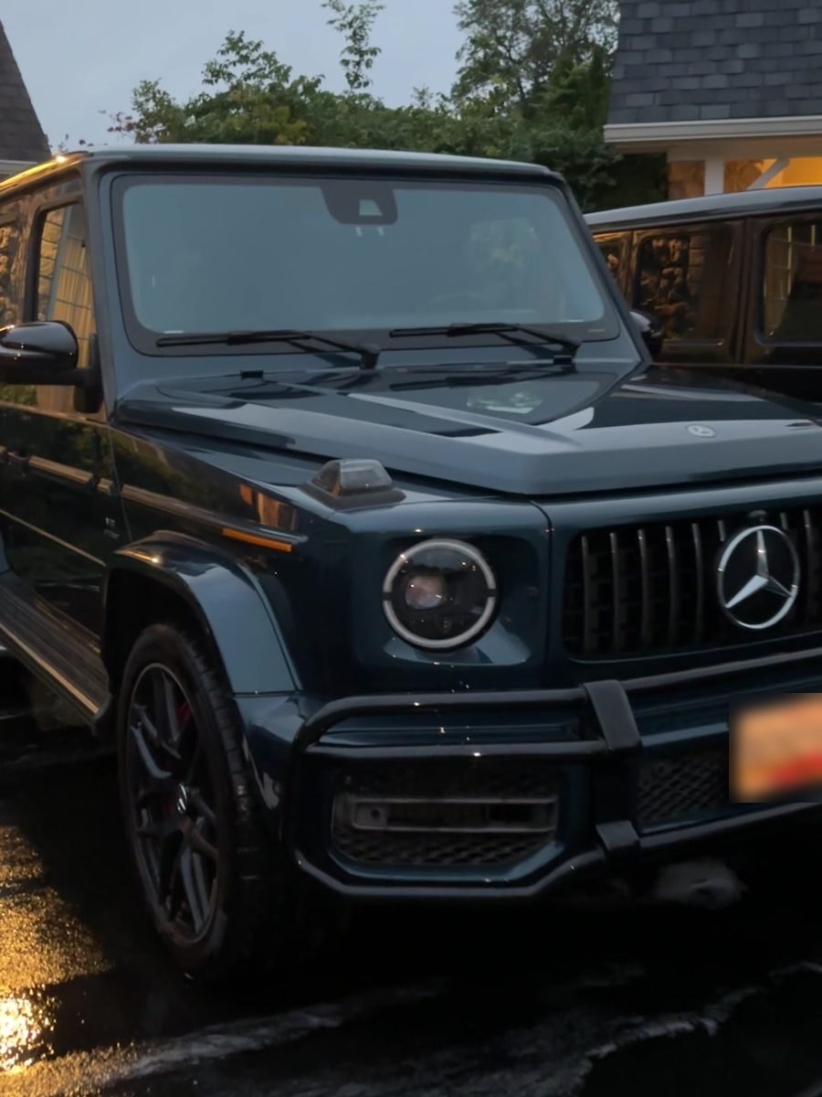 Black Mercedes-AMG G63 after an exterior detail in a home driveway.