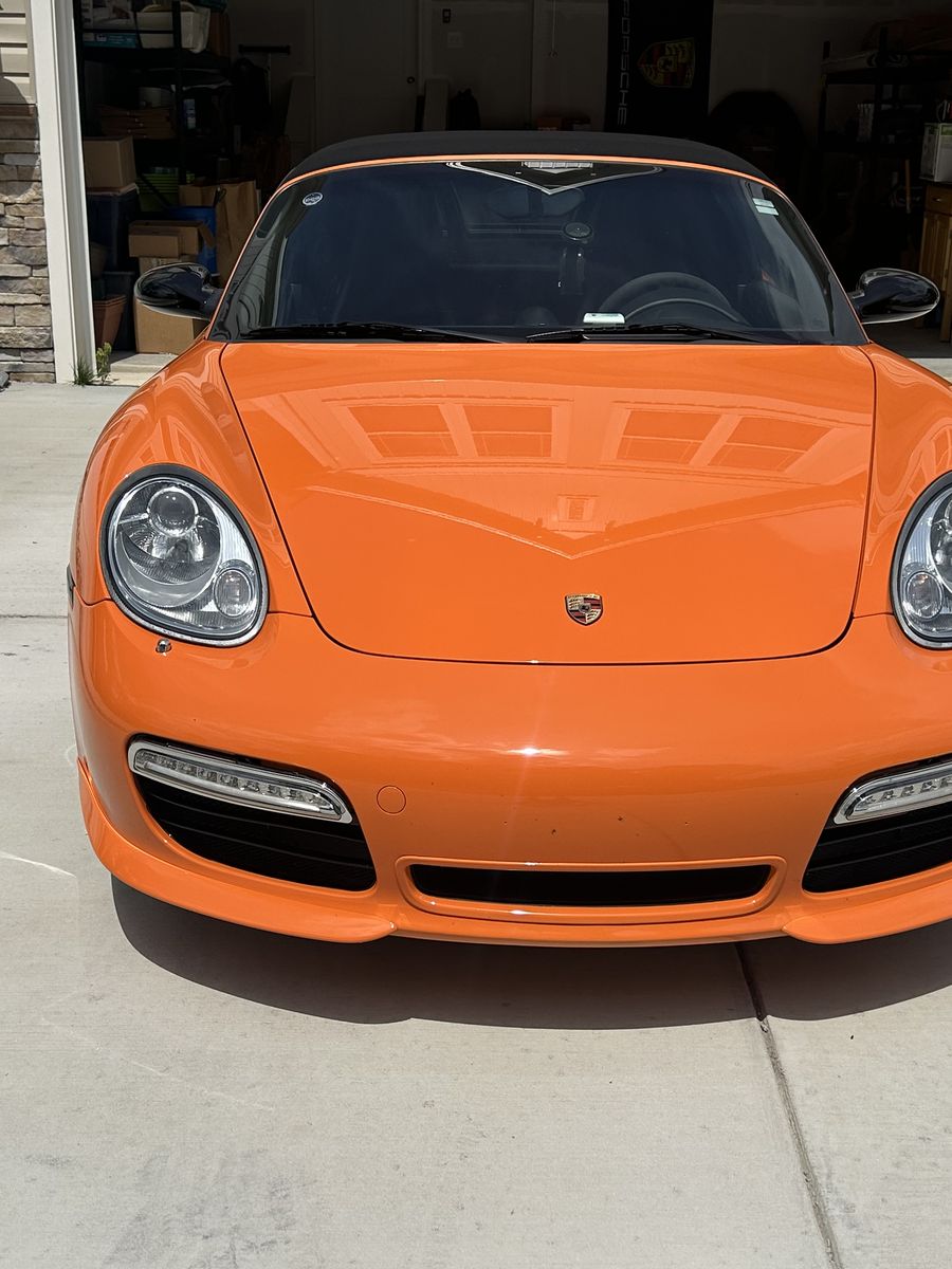 Orange Porsche Boxster with a high-gloss finish after an exterior detail.