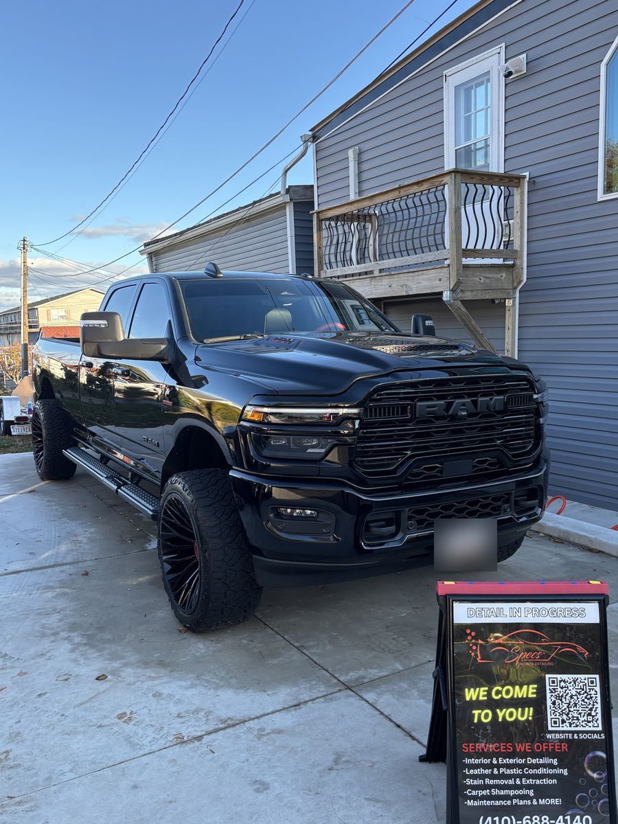 Black Ram Heavy Duty pickup after a full exterior detail, with the Specs Mobile Detailing sign.